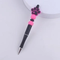Detail of DIY beaded pen featuring pink and black silicone cat paw topper and round beads - Rose Red