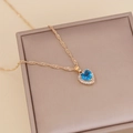 Golden heart necklace featuring a blue zircon pendant on a vintage twisted chain - Dark Blue