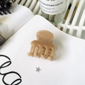 Beige matte claw clip hair accessory placed on a minimalist white open notebook - Dark Nude Pink (Medium 4.8cm)