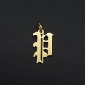 Macro shot of gold stainless steel gothic letter P charm pendant on black background - Letter P