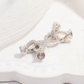 Macro shot of S925 silver pearl connector with cubic zirconia and four cup settings - Style E: White Gold Four-legged Figure-eight Buckle