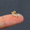Delicate gold-plated butterfly wing ear stud with zircon stones on a person's fingertip - CC111-2 Gold Curved Zirconia