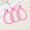 Three rose pink silicone cable ties with non-slip threaded texture for accessories - Peach Pink