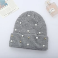 Close-up of grey ribbed knit beanie featuring elegant faux pearls and metallic bead accents - Light Gray