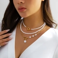 Double-layer gold necklace with faux pearls and OT clasp shown on model - Style 15/Double Layer / Gold