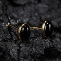 Detailed macro view of gold-plated 925 silver stud earrings with oval black jasper stones - Natural Black Agate Oval Gold 5*7mm
