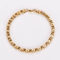 Macro shot of 18K gold plated stainless steel bracelet with floral links and lobster clasp - Gold