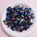 Close-up of rainbow gradient bow beads in a white tray for DIY jewelry making - Sold per piece / Black