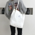 White canvas tote bag with large capacity featuring vintage buttons and leaf patch logo - White
