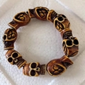 Punk brown skull bead elastic bracelet with carved bone-like details on white surface - Light Brown