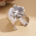 Detailed macro view of the layered metal flower petal design on a silver polished cuff - Silver