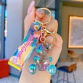 Iridescent geometric crystal bear keychain with aurora resin finish and purple hand strap - Grey Green