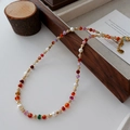 Beaded vintage necklace with red agate, pearls and gold spacers on a wood tray - Colorful Agate Necklace XL0208