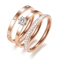 Detail of three-piece rose gold stackable rings featuring round zircon and pavé setting - US 5 / Rose Gold