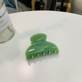 Close-up of a glossy green heart-shaped plastic hair claw clip with smooth edges - Approx 6.8cm / Leaf Green