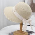 Detail of beige straw hat with cream ribbon, bow, and gold 'GO SWEET' metal tag - Beige