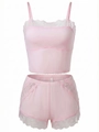 Detail of pink sleepwear set featuring intricate white lace trim on the camisole and shorts - S / Pink