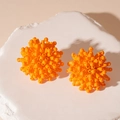 Macro shot of bright orange cluster stud earrings on white textured stone background - Orange Flower (S925 Silver Needle)