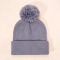 Close-up of purple knitted beanie with a matching pompom showing soft wool textures - One Size / Gray