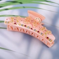 Pink ribbon hair claw clip with sparkling rhinestones and floral bow design features - Pink