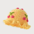 Detailed knit texture of a yellow handmade crochet bucket hat with 3D cherry accents - One Size / Yellow