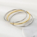 Close-up of interlocked 3mm round wire bangles in polished silver and gold finish - 3 Rings (1 Gold + 2 Steel)