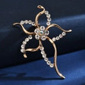 Macro shot of gold abstract flower brooch with shimmering crystals and iridescent gem - Iridescent Starfish
