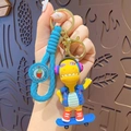 Yellow cartoon dinosaur keychain with blue surfboard, pink sunglasses and blue wrist strap - Sports Dinosaur - Blue Skateboard
