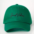 Close-up of high-quality Good Vibes embroidery on a green cotton baseball cap - Olive Green