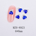 Macro view of 6x8mm heart-shaped blue cat-eye nail art charms with silver diamond base - Silver Heart Style With Blue Crystal (8923)