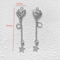 Detailed view of silver heart tassel pendant with star charm and 55mm length scale - White Heart Tassel