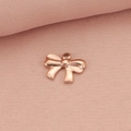 Elegant rose gold bow pendant in stainless steel displayed on soft pink fabric - Rose Gold Bow 3 Pendant