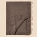 Detail of soft brown cotton knitted baby blanket with delicate ripple edges and texture - Dark Coffee