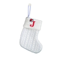Close-up of white cable knit Christmas stocking with red embroidered letter J detail - Letter J