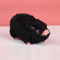 Squishy black silicone toy pig with pink snout and ears on a pink background - Flesh Pink Pig with Black Hair 108g