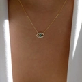 Detail of gold evil eye necklace with green gem and white zircons on female model - Gold Thin Chain Green Stone Eye Pendant