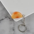 Realistic PVC garlic clove keychain with a glossy orange finish and silver metal ring - Roasted Garlic Clove - Keychain / Roasted Color