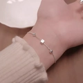 Minimalist silver chain bracelet featuring geometric cube and beads on woman's wrist - Silver Ultra-Fine Round Bead Geometric Cube (MY35585)
