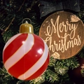 Inflatable red and white spiral stripe Christmas ball hanging from a lush holiday tree - Small Gold Thread Spiral