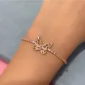 Pink zircon butterfly bracelet with silver base and delicate gold plating on model's wrist - Butterfly - Silver