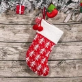 Knitted red Christmas stocking with white tree patterns and decorative poms - Red and White Christmas Tree