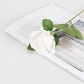 Artificial white velvet rose with green leaves on an open magazine for home decor - Small Velvet White