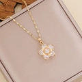 Elegant gold-plated multi-layer flower necklace with zircon petals on a beige jewelry box - White