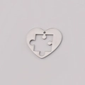 Polished silver stainless steel heart pendant with puzzle piece cutout on white background - Large (25x22mm) / Steel