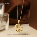 Macro shot of gold titanium heart pendant with Mom lettering and zircon stones - Gold Heart Necklace N0454G