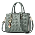 Green PU leather handbag with wavy quilted texture and golden butterfly charm - Green