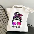 White canvas tote bag featuring Nurse Life print with leopard bow on a black chair - Style C8 (No Inner Pocket/No Zipper)