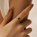 Detail of minimalist 18K gold ring with oval green gemstone on model's finger - Adjustable Open / Green (KR0045-3)