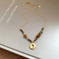 Detail of tiger eye beads and golden O-ring pendant on an autumn vintage necklace - Hollow Round Style (12#) / Gold
