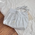 Detail of a ruffled canvas tote bag featuring blue polka dots and a bow shoulder strap - Blue Polka Dot